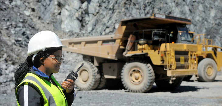 A miner is holding a portable radio1 PD780 E11